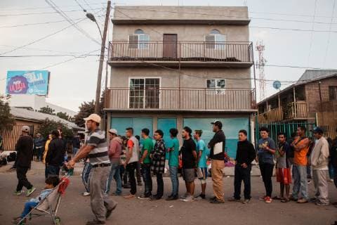 Migrants that are part of the caravan from Central America wait in line for food in front of the makeshift migrant shelter at Unidad Deportiva Benito Juarez Stadium on November 26, 2018 in Tijuana, Mexico. Sunday afternoon, some migrants protesting a backlog of asylum claims rushed toward the border and were met with tear gas.  TIJ2018112611 ARIANAxDREHSLER