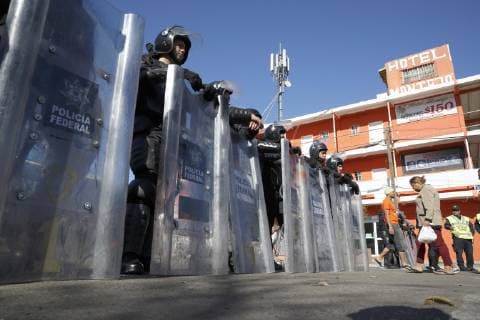 Migrant caravan Police officers stand guard in Tijuana, Mexico, on Nov. 26, 2018, near a shelter for migrants from Central America. 