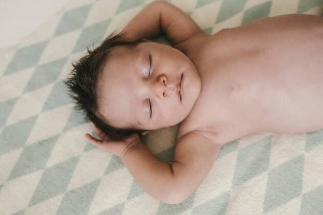 Portrait of a newborn baby boy lying on a blanket with closed eyes model released Symbolfoto property released  MFF04594