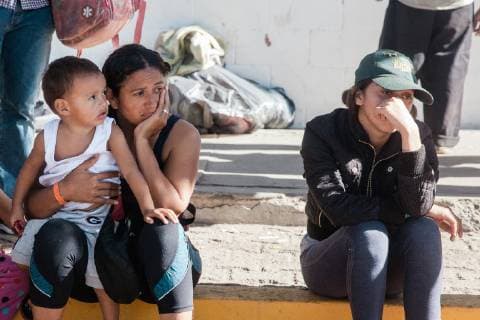 Tired families wait outside the makeshift shelter, Benito Juarez, in Tijuana, Mexico on November 27, 2018.  TIJ2018112709 ARIANAxDREHSLER