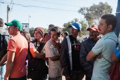 Men wait in line at the ICRC tent, set up to assist migrants in contacting their families, in front of the Benito Suarez shelter on November 27, 2018 in Tijuana, Mexico. Migrants, refugees and asylum seekers are congregating south of the U.S. border  TIJ2018112710 ARIANAxDREHSLER