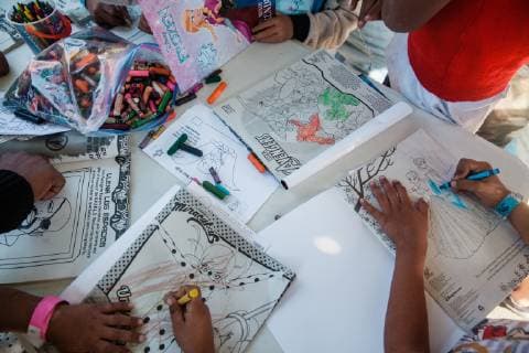 Children color at a table set up by a group of volunteers from Groupo Unitad (United Group), a Christian group, near the Benito Suarez shelter in Tijuana, Mexico on November 27, 2018. Migrants, refugees and asylum seekers are congregating south of the U.S. border  TIJ2018112719 ARIANAxDREHSLER