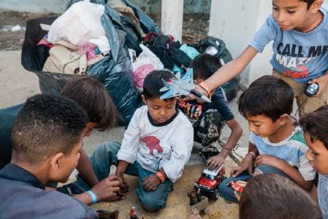 Children play with toys outside the Benito Juarez shelter in Tijuana, Mexico on November 27, 2018. 5,800 migrants and asylum seekers are staying at the shelter waiting for a chance to enter the U.S.  TIJ20181127202 ARIANAxDREHSLER