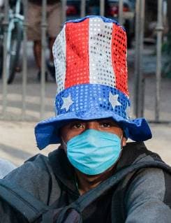 A young man who traveled with the migrant caravan waits in line for food in front of the Benito Juarez migrant shelter in Tijuana, Mexico on November 27, 2018. At present, 5,800 migrants and asylum seekers are staying at the shelter waiting for a chance to enter the U.S.  TIJ20181127214 ARIANAxDREHSLER