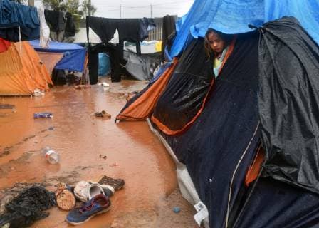 November 29, 2018 - Tijuana, Mexico - People navigate severe flooding at the migrant caravan camp Centro Deportivo Benito Juarez on November 29, 2018. It is being called a humanitarian crisis. IMELDA LIMA LOPEZ and her twins look at dirty water at their tent. SAIRA MAVEC MEZA, 5 years old, developed a rash from the tear gas said her mother. They were the focus of an image by Reuters photojournalist Kim Kyung-Hoon taken as they ran from tear gas fired by U.S. agents during chaos at the border on Sunday. The photo went viral. She came from Honduras with five children. She has nine total, 3 still in Honduras and 1 in Louisiana. We lost everything, said a migrant walking through debris. Many migrants appeared to realize that the hope they held to begin a new life in America had dimmed and their stay in Mexico may be longer than anticip - ZUMAg208 20181129_zap_g208_010 Copyright: xCarolxGuzyx