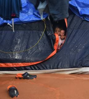 November 29, 2018 - Tijuana, Mexico - People navigate severe flooding at the migrant caravan camp Centro Deportivo Benito Juarez on November 29, 2018. It is being called a humanitarian crisis. IMELDA LIMA LOPEZ and her twins look at dirty water at their tent. SAIRA MAVEC MEZA, 5 years old, developed a rash from the tear gas said her mother. They were the focus of an image by Reuters photojournalist Kim Kyung-Hoon taken as they ran from tear gas fired by U.S. agents during chaos at the border on Sunday. The photo went viral. She came from Honduras with five children. She has nine total, 3 still in Honduras and 1 in Louisiana. We lost everything, said a migrant walking through debris. Many migrants appeared to realize that the hope they held to begin a new life in America had dimmed and their stay in Mexico may be longer than anticip - ZUMAg208 20181129_zap_g208_011 Copyright: xCarolxGuzyx