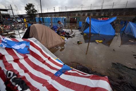 November 29, 2018 - Tijuana, Mexico - People navigate severe flooding at the migrant caravan camp Centro Deportivo Benito Juarez on November 29, 2018. It is being called a humanitarian crisis. We lost everything, said a migrant walking through debris. Many migrants appeared to realize that the hope they held to begin a new life in America had dimmed and their stay in Mexico may be longer than anticipated. Tijuana Mexico - ZUMAg208 20181129_zap_g208_006 Copyright: xCarolxGuzyx