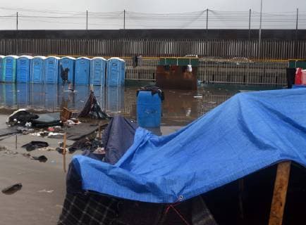 November 29, 2018 - Tijuana, Mexico - People navigate severe flooding at the migrant caravan camp Centro Deportivo Benito Juarez on November 29, 2018. It is being called a humanitarian crisis. We lost everything, said a migrant walking through debris. Many migrants appeared to realize that the hope they held to begin a new life in America had dimmed and their stay in Mexico may be longer than anticipated. Tijuana Mexico - ZUMAg208 20181129_zap_g208_003 Copyright: xCarolxGuzyx