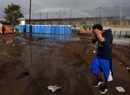 November 29, 2018 - Tijuana, Mexico - A rainbow briefly appears over camp. People navigate severe flooding at the migrant caravan camp Centro Deportivo Benito Juarez on November 29, 2018. It is being called a humanitarian crisis. We lost everything, said a migrant walking through debris. Many migrants appeared to realize that the hope they held to begin a new life in America had dimmed and their stay in Mexico may be longer than anticipated. Tijuana Mexico - ZUMAg208 20181129_zap_g208_008 Copyright: xCarolxGuzyx