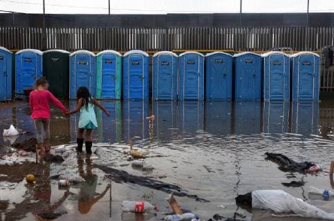 November 29, 2018 - Tijuana, Mexico - People navigate severe flooding at the migrant caravan camp Centro Deportivo Benito Juarez on November 29, 2018. It is being called a humanitarian crisis. We lost everything, said a migrant walking through debris. Many migrants appeared to realize that the hope they held to begin a new life in America had dimmed and their stay in Mexico may be longer than anticipated. Tijuana Mexico - ZUMAg208 20181129_zap_g208_001 Copyright: xCarolxGuzyx