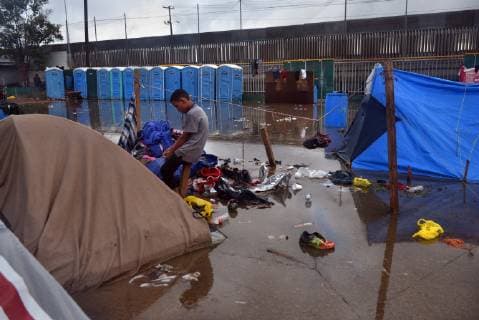November 29, 2018 - Tijuana, Mexico - People navigate severe flooding at the migrant caravan camp Centro Deportivo Benito Juarez on November 29, 2018. It is being called a humanitarian crisis. We lost everything, said a migrant walking through debris. Many migrants appeared to realize that the hope they held to begin a new life in America had dimmed and their stay in Mexico may be longer than anticipated. Tijuana Mexico - ZUMAg208 20181129_zap_g208_004 Copyright: xCarolxGuzyx