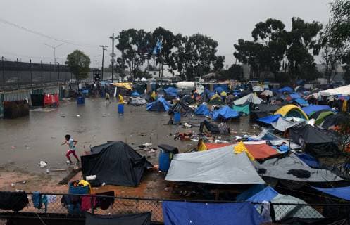 November 29, 2018 - Tijuana, Mexico - People navigate severe flooding at the migrant caravan camp Centro Deportivo Benito Juarez on November 29, 2018. It is being called a humanitarian crisis. We lost everything, said a migrant walking through debris. Many migrants appeared to realize that the hope they held to begin a new life in America had dimmed and their stay in Mexico may be longer than anticipated. Tijuana Mexico - ZUMAg208 20181129_zap_g208_017 Copyright: xCarolxGuzyx