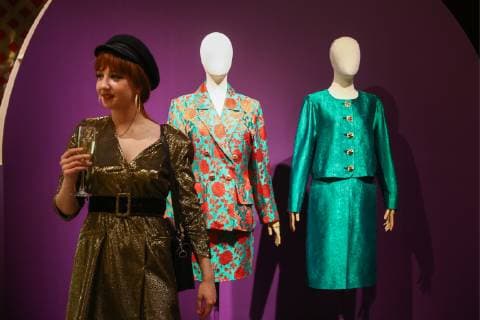 MOSCOW, RUSSIA - DECEMBER 4, 2018: A girl seen by exhibits on display at an exhibition titled The Glamour of the 80s by Russian fashion historian Alexandre Vassiliev opened at the VDNKh exhibition centre. The exhibition shows a unique collection of the 1980s costumes by Chanel, Christian Dior, Yves Saint Laurent, Givenchy, Pierre Balmain, Claude Montana, and other fashion houses. Mikhail Tereshchenko TASS  TS099C8C