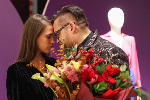 MOSCOW, RUSSIA - DECEMBER 4, 2018: Russian fashion historian Alexandre Vassiliev with a girl at the opening of his exhibition titled The Glamour of the 80s at the VDNKh exhibition centre. The exhibition shows a unique collection of the 1980s costumes by Chanel, Christian Dior, Yves Saint Laurent, Givenchy, Pierre Balmain, Claude Montana, and other fashion houses. Mikhail Tereshchenko TASS  TS099CCC