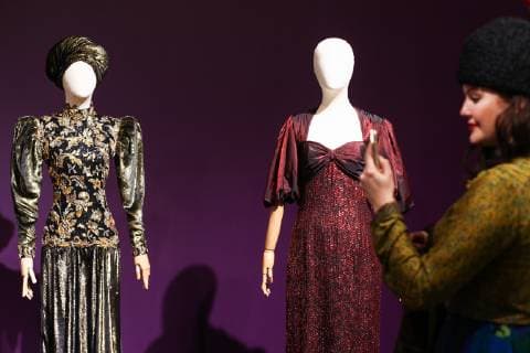 MOSCOW, RUSSIA - DECEMBER 4, 2018: A silk velvet dress by the Jean-Louis Scherrer fashion house (Paris, 1985), part of French actress Cyrielle Clair s collection (L), and a shot silk evening gown by the Frank Usher fashion house (London, early 1980s), on display at an exhibition titled The Glamour of the 80s by Russian fashion historian Alexandre Vassiliev opened at the VDNKh exhibition centre. The exhibition shows a unique collection of the 1980s costumes by Chanel, Christian Dior, Yves Saint Laurent, Givenchy, Pierre Balmain, Claude Montana, and other fashion houses. Mikhail Tereshchenko TASS TS099CB9