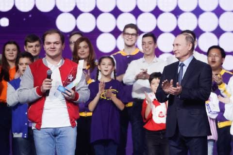 MOSCOW, RUSSIA - DECEMBER 5, 2018: The President of Russia Vladimir Putin (R) and Dobrovolets Rossii prize winners at the 2018 Dobrovolets Rossii (Volunteer of Russia) award ceremony at CSKA Arena on International Volunteer Day; the event is part of the 2018 International Volunteer Forum; left; Dobrovolets Rossii prize winner Anton Korotchenko. Mikhail Metzel TASS  TS099E1A