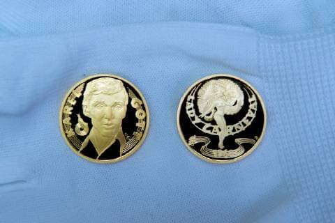Czech famous singer Karel Gott (not seen) solemnly coined gold (pictured) and silver medals with his own portrait for the series Slavici ve zlate (Nightingales in gold) in the Czech Mint, on December 5, 2018, in Jablonec nad Nisou, Czech Republic. (CTKxPhoto RadekxPetrasek) CTKPhotoP201812050501301  PER 2