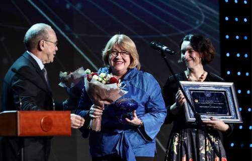 MOSCOW, RUSSIA - DECEMBER 7, 2018: The Director of the Zapovedniki environmental educational centre Natalya Danilina (C), and the Deputy Director of the Zapovedniki environmental educational centre Yelena Knizhnikova (R), receive a 2018 Russian Geographical Society Prize in the Best Educational Project in the Field of Geography category from TV personality, Head of the Department of World Literature and Culture at MGIMO, Yury Simonov (Vyazemsky) during the award ceremony at the State Kremlin Palace. Anton Novoderezhkin TASS  TS09A50C