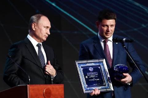 MOSCOW, RUSSIA - DECEMBER 7, 2018: The Head of the Krasnoyarsk branch of the Russian Geographical Society, Igor Spiridenko (R), receives the 2018 Russian Geographical Society Prize in the Best Expedition in Russia category from the President of Russia Vladimir Putin at the award ceremony at the State Kremlin Palace; Igor Spiridenko was among those who organized the evacuation of the wreckage of a Douglas S-47 aircraft from the tundra to Krasnoyarsk, the aircraft was sent to the USSR during the Great Patriotic War on lend-lease from the United States. Anton Novoderezhkin TASS  TS09A521