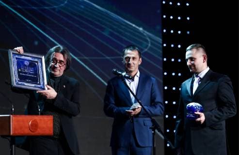 MOSCOW, RUSSIA - DECEMBER 7, 2018: Diver, participant in the project Submerged Shrines of the Mologa Region Alexei Ivanov (C) and Dmitry Radchenko of the Trety Rim non-governmental organisation (R) receive a 2018 Russian Geographical Society Prize in the Best Historical and Cultural Project category from the artistic director of the Moscow Soloists ensemble, conductor Yuri Bashmet during the award ceremony at the State Kremlin Palace. Anton Novoderezhkin TASS  TS09A543