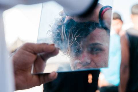 Jose Hernandez, 17 years old, styles his hair at El Barretal shelter in Tijuana, Mexico on December 9, 2018. Hernandez traveled without his family from Honduras in hopes of seeking asylum in the United States.  TJ2018120924 ARIANAxDREHSLER