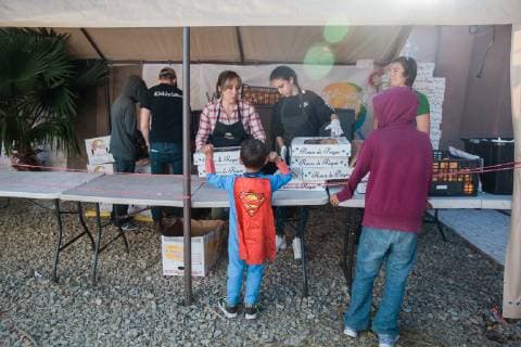 A child wearing a superman cape talks t the volunteers at El Barretal shelter located in the eastern part of Tijuana, Mexico on December 9, 2018.  TJ2018120918 ARIANAxDREHSLER