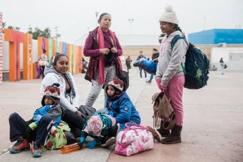 Brenda and Jensina wait in the morning for their number to be called at El Chaparral in Tijuana, Mexico on December 10, 2018. They left Guerrero, Mexico for Tijuana because of the violence and would like a better future for their children. They hope to seek asylum in the US and move to Ontario, California where they have a friend who is already living there.  TJ2018121006 ARIANAxDREHSLER