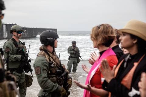 Border Patrol agents face off demonstrators at Border Field State Park in San Diego, California on December 10, 2018. Over 300 demonstrators gathered including faith leaders from churches, mosques, synagogues and indigenous communities to show support for migrants who would like to seek asylum in the United States.  SDP2018121040 ARIANAxDREHSLER