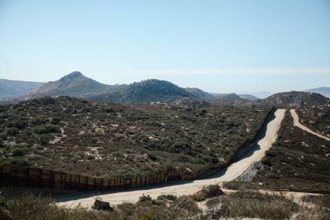 The metal border fence extends across a valley dividing the United States and Mexico in Campo, California on December 16, 2018.  SDP2018121603 ARIANAxDREHSLER