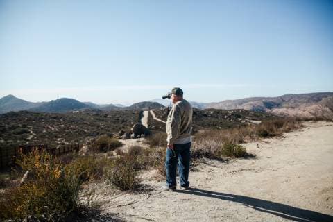 Terry Marshall, a member of the Minuteman Civil Defense Corp in Iowa, looks over into Mexico with his binoculars from Campo, California to see if he spots anyone walking on December 16, 2018. Marshall arrived in Campo on December 1 and claims he has helped US Border Patrol spot and identify 16 illegal crossings from Mexico.  SDP2018121615 ARIANAxDREHSLER