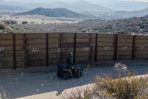 A US Border Patrol agent rides an ATV in Campo, California as he polices near the border fence that divides the United States and Mexico on December 16, 2018.  SDP2018121623 ARIANAxDREHSLER