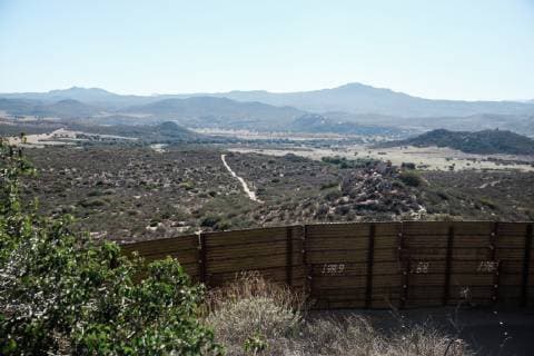 A section of the metal border fence extends across the valley dividing the United States and Mexico in Campo, California on December 16, 2018.  SDP2018121621 ARIANAxDREHSLER
