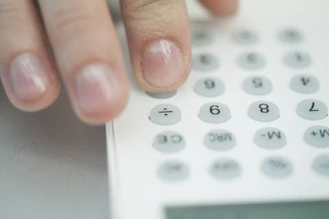 Woman using calculator, extreme close-up  Copyright: AlexVentura B64350321