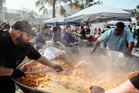 Volunteers cook paella in a huge pan for the migrants staying at El Baterral shelter in Tijuana, Mexico on December 23, 2018. The U.S. government is in a partial shutdown after President Trump refused to sign a bipartisan agreement, holding out for $5 billion to build an expanded border wall.  TIJ2018122322 ARIANAxDREHSLER