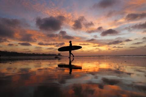 December 23, 2018 - San Diego, California, U.S - December 23, 2018 - San Diego, California, USA - A surfer walks out of the water during a low tide at sunset at La Jolla Shores Beach. San Diego U.S. - ZUMAa97_ 20181223_zaf_a97_004 Copyright: xKCxAlfredx