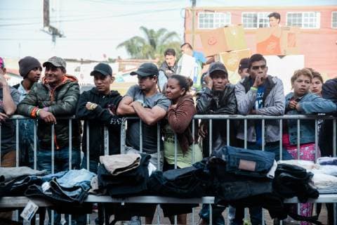 Migrants who traveled from Central America wait in line in front of Contra Viento y Marea shelter to pick clothes that have been donated in Tijuana, Mexico on December 23, 2018. The U.S. government is in a partial shutdown after President Trump refused to sign a bipartisan agreement, holding out for $5 billion to build an expanded border wall.  TIJ2018122309 ARIANAxDREHSLER