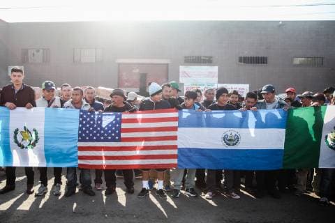 Migrants who traveled from Central America hold various flags in Tijuana, Mexico, to represent their country along with the United States flag to represent where they would like to start their new life on December 23, 2018. The U.S. government is in a partial shutdown after President Trump refused to sign a bipartisan agreement, holding out for $5 billion to build an expanded border wall.  TIJ2018122304 ARIANAxDREHSLER