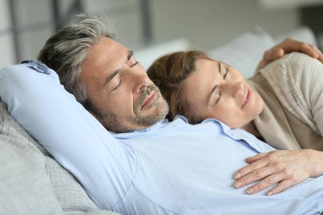  Mature couple having a rest laying down in sofa model released Symbolfoto  Copyright: xGoodluzx Panthermedia17829800