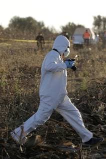 (181225) -- PUEBLA, Dec. 25, 2018 () -- A forensic member works at the helicopter crash site in Coronango, Puebla, Mexico, Dec. 24, 2018. The governor of Mexico s central state of Puebla, Martha Erika Alonso, and her husband Rafael Moreno Valle, ex-governor of the state, were killed in a helicopter crash on Monday, the head of the National Action Party Marko Cortes confirmed. ( Str) (rtg) MEXICO-PUEBLA-ACCIDENT-HELICOPTER CRASH XINHUA