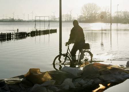 A man is driving on the flooded federal highway B187 in Elster Saxony Anhalt on Wednesday 5 April 2006 The Elbe flood reaches its highest level in Saxony Anhalt on Thursday Eckehard Schulz A man rides bicycle on a flooded road next the river Elbe in Elster eastern Germany Wednesday April 5 2006 Eckehard Schulz ELSTER DEU