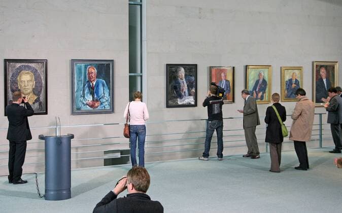 Reporters watch the portraits of the German Chancellors in the Chancellor Gallery in the Federal Chancellery in Berlin Eckehard Schulz Reporters look at portraits of the German chancellors in the Chancellor Gallery in the Federal Chancellery in Berlin Tuesday July 10 2007 The last portrait of Gerhard Schroeder left was painted by German artist Joerg Immendorf Eckehard Schulz