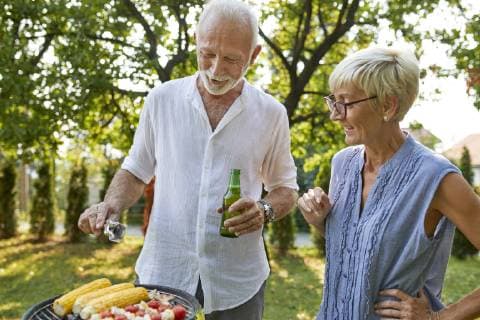 Senior couple having a barbecue in garden model released Symbolfoto property released  ZEDF01597