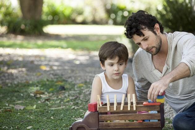 Father and son playing with toys in backyard  Copyright: AlexVentura B10105934