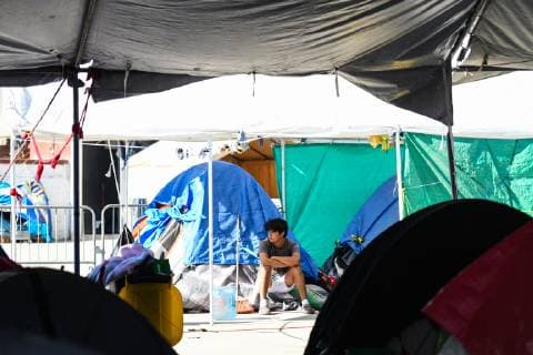 (190110) -- TIJUANA, Jan. 10, 2019 -- A migrant is in a temporary transit center for migrants from Central America in Tijuana, Mexico, Jan. 9, 2019. A large number of migrants from Central America gathered in Mexican border city Tijuana wishing to enter the United States. ) MEXICO-TIJUANA-MIGRATION-CENTRAL AMERICA-U.S. XinxYuewei 