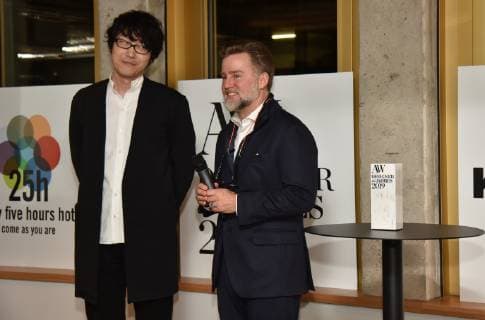 The Japanese designer Oki Sato alias NENDO winner of the A W Designer of the Year 2019 Prize l and Jörn Frederic Kengelbach Editor-in-Chief A W Architektur Wohnen r poses in Cologne on 13 01 2019