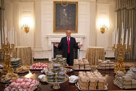 January 14, 2019 - Washington, DC, United States of America - U.S President Donald Trump stands behind a spread of fast food that he purchased for the celebration for the 2018 NCAA College Football National Champion Clemson Tigers in the State Dining Room of the White House January 14, 2019 in Washington, DC. Due to constraints from the partial government shutdown, the president purchased a selection of fast food from Dominos, McDonalds, Wendys and Burger King. Washington United States of America - ZUMAp138 20190114_zaa_p138_005 Copyright: xJoycexN.xBoghosianx
