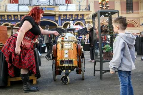 January 18, 2019 - London, United Kingdom - A woman is seen with Dalek at the Steam of Steampunk stand at annual London Model Engineering Exhibition at Alexandra Palace, north London. Over 50 clubs and societies are exhibiting full spectrum of modelling from traditional model engineering, steam locomotives and traction engines through to the more modern gadgets including trucks, boats, aeroplanes and helicoptersÃäwith nearly 2,000 models constructed by their members. London United Kingdom - ZUMAs197 20190118_zaa_s197_064 Copyright: xDinendraxHariax