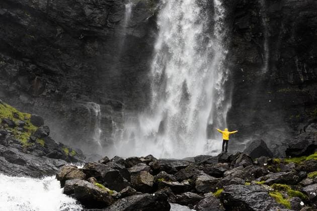 Hiker at Fossa waterfall, Streymoy island, Faroe Islands, Denmark, Europe Copyright: RobertoxMoiola 1179-3651