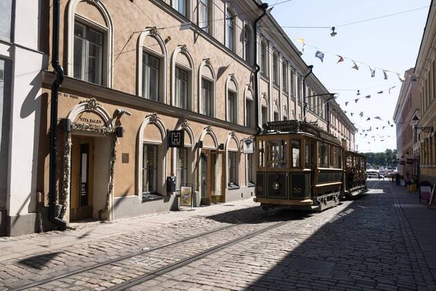 Tram travels through row of houses Helsinki Finland Europe Copyright: imageBROKER/SonjaxJordan ibljor04824992.jpg