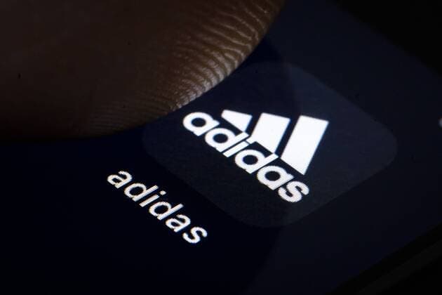 Symbol photo A finger on a smartphone taps on the logo of adidas Berlin 07 02 2019 Berlin Germany Copyright: xThomasxTrutschel photothek.netx